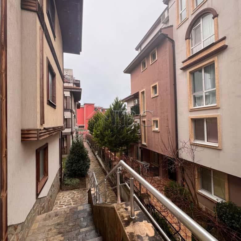 View of neighboring buildings and greenery from a balcony in Sveti Vlas.