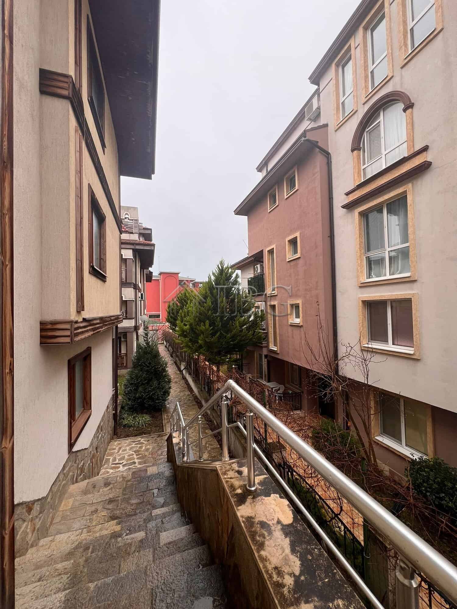 View of neighboring buildings and greenery from a balcony in Sveti Vlas.