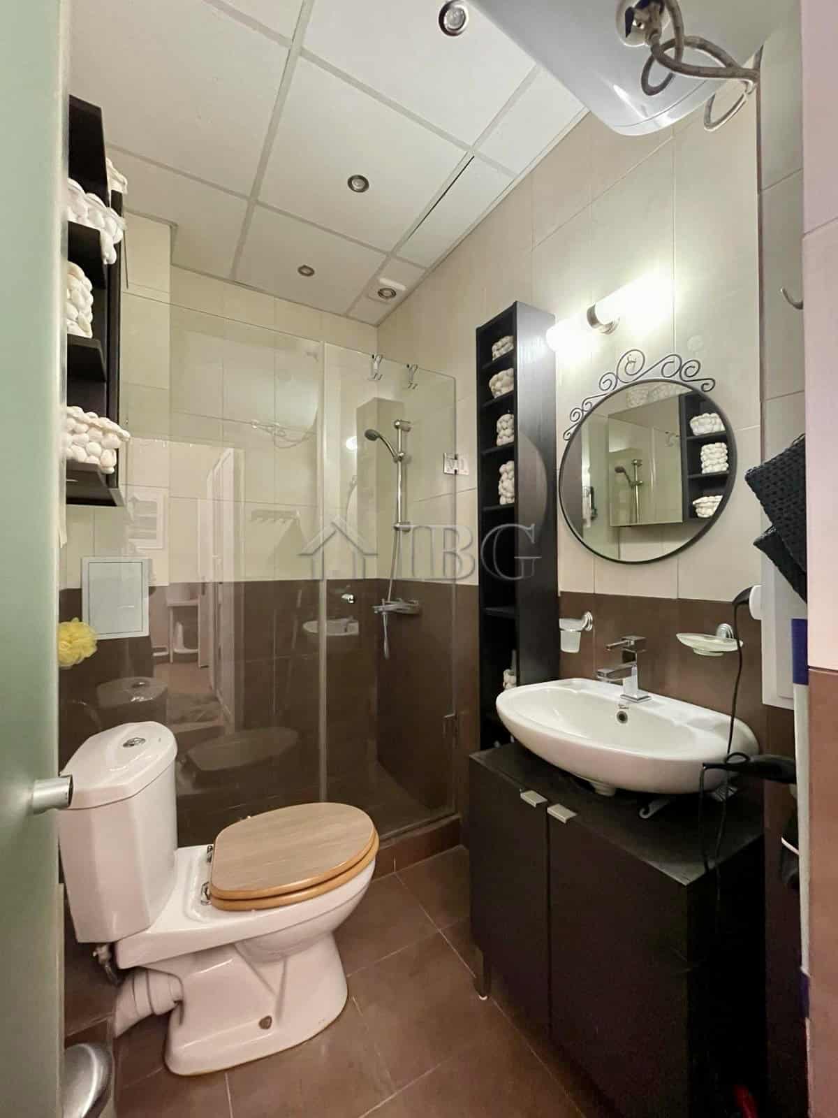 Bright, clean bathroom with shower, toilet, and vanity in Sun Gate, Sunny Beach.
