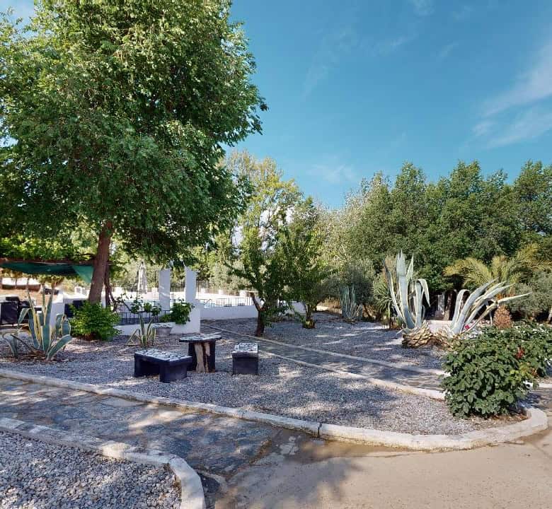 Boutique hotel for sale in Caniles, Granada, Spain, featuring charming outdoor gardens and lush gree.