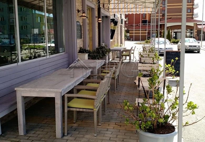 Outdoor dining area of a restaurant in Nessebar with tables and chairs.