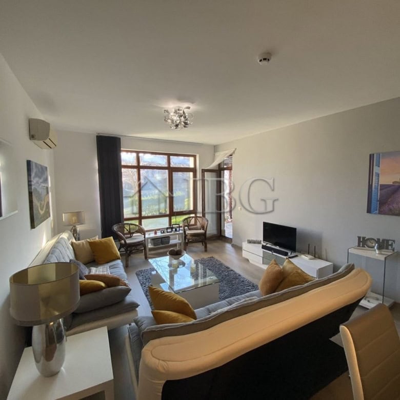 Bright living room with large windows and elegant furniture.