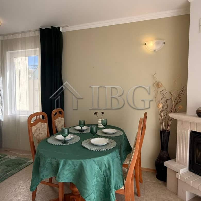 Interior of a 2-bedroom apartment with sea view, dining area, and fireplace in Sveti Vlas.