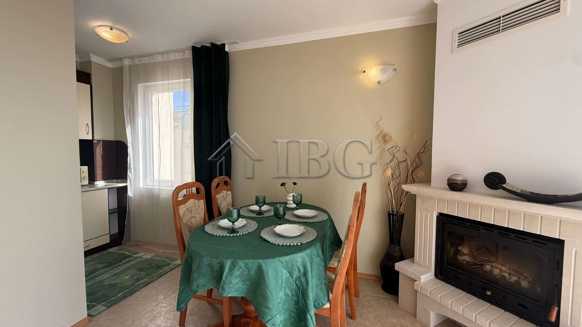 Interior of a 2-bedroom apartment with sea view, dining area, and fireplace in Sveti Vlas.