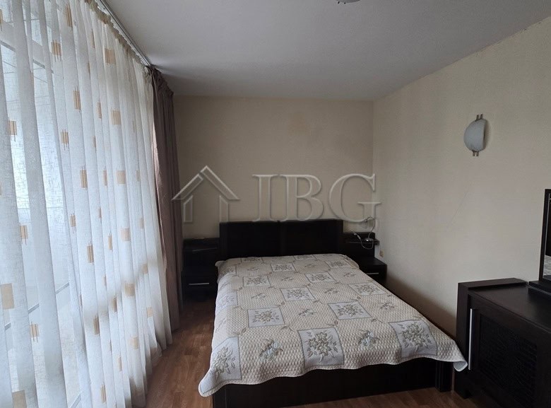Modern bedroom with a large bed and balcony view in Sunny Beach, Bulgaria.