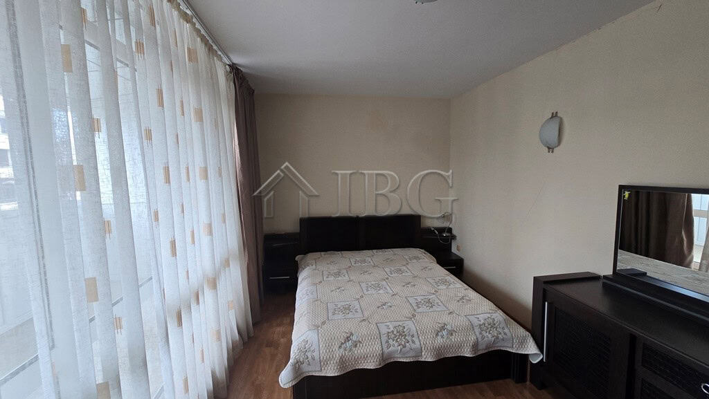 Modern bedroom with a large bed and balcony view in Sunny Beach, Bulgaria.