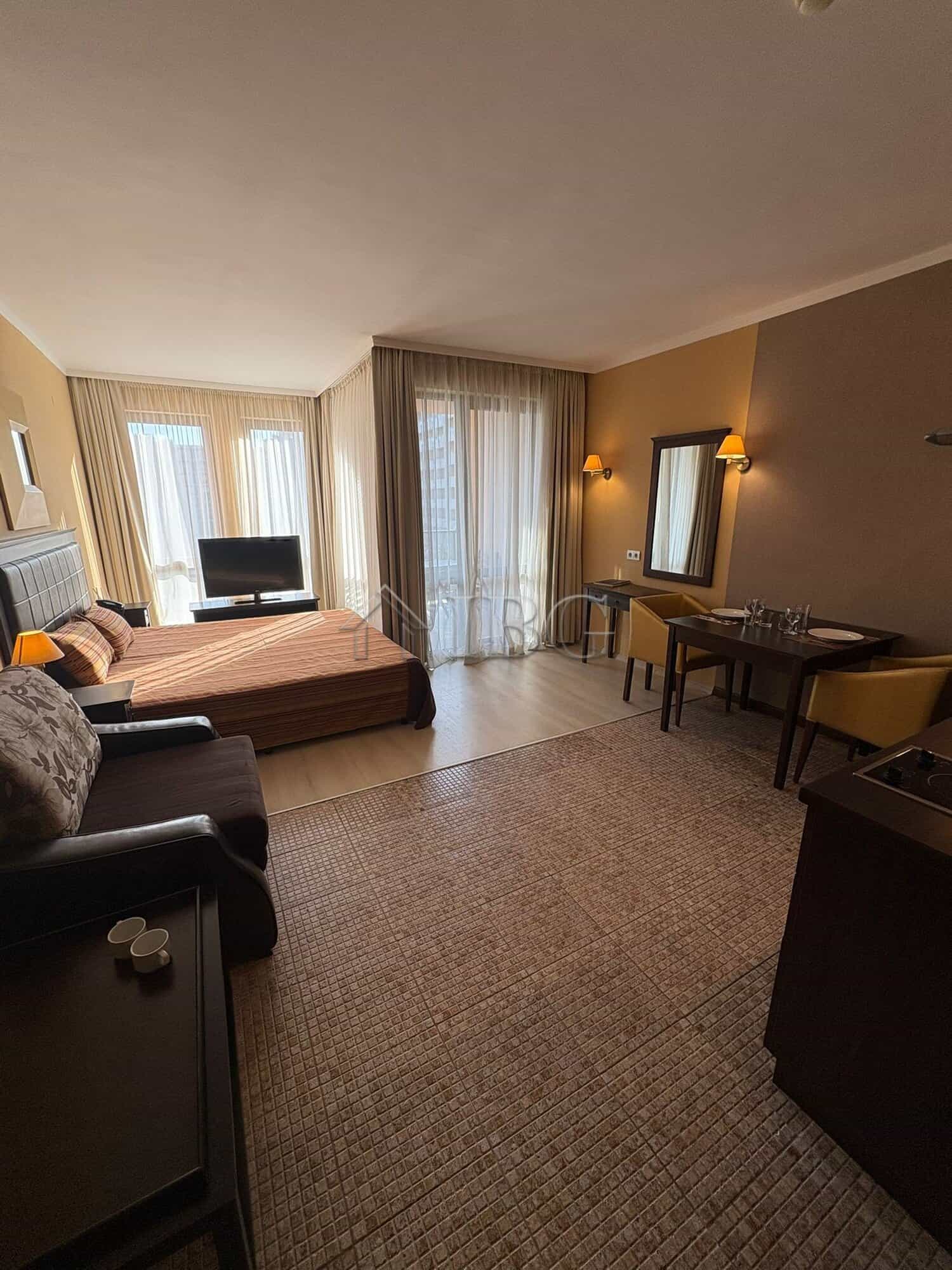 Spacious Studio with Pool View at Royal Beach Barceló Modern studio apartment with pool view in Sunny Beach, featuring a comfortable sleeping area, seatin.