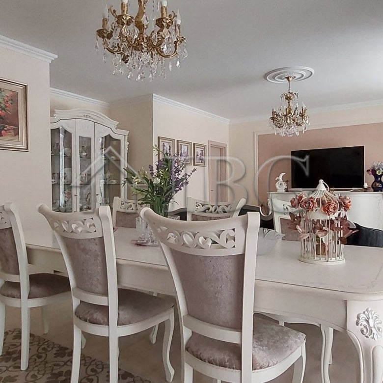 Elegant living room with classic furniture and chandelier in Sarafovo townhouse.