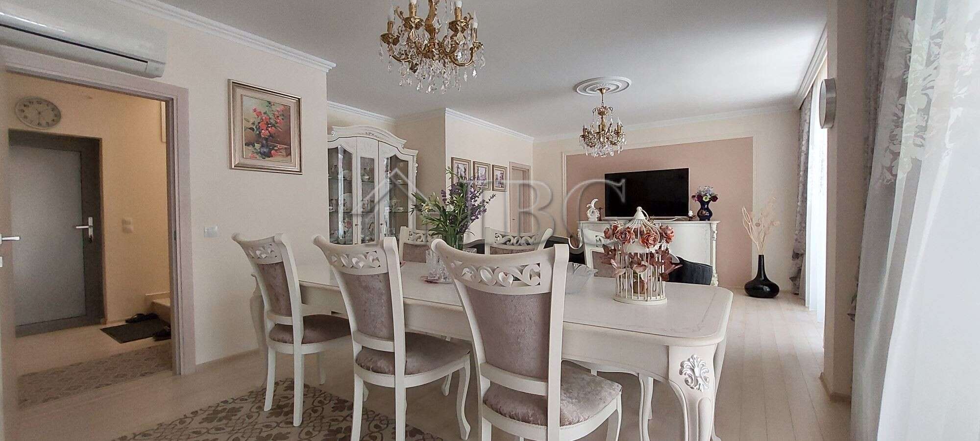 Elegant living room with classic furniture and chandelier in Sarafovo townhouse.