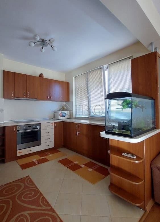 Bright kitchen with modern cabinets and a fish tank in Burgas home.