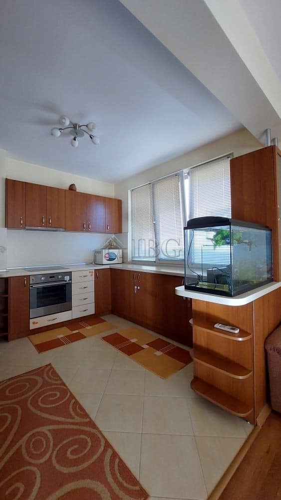 Bright kitchen with modern cabinets and a fish tank in Burgas home.