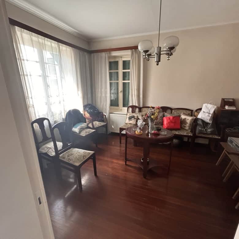 Bright living room with large windows and elegant furniture.