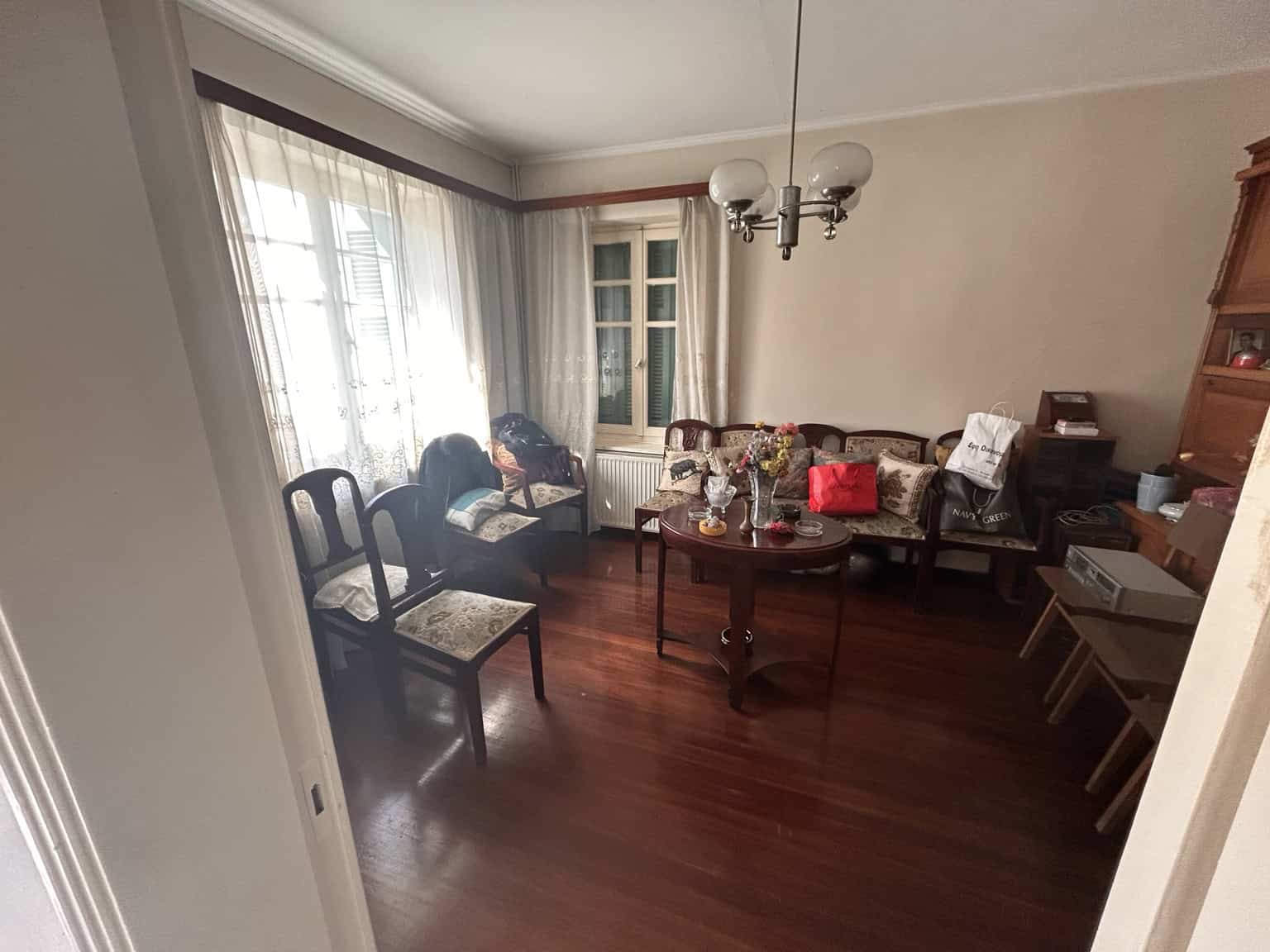 Bright living room with large windows and elegant furniture.