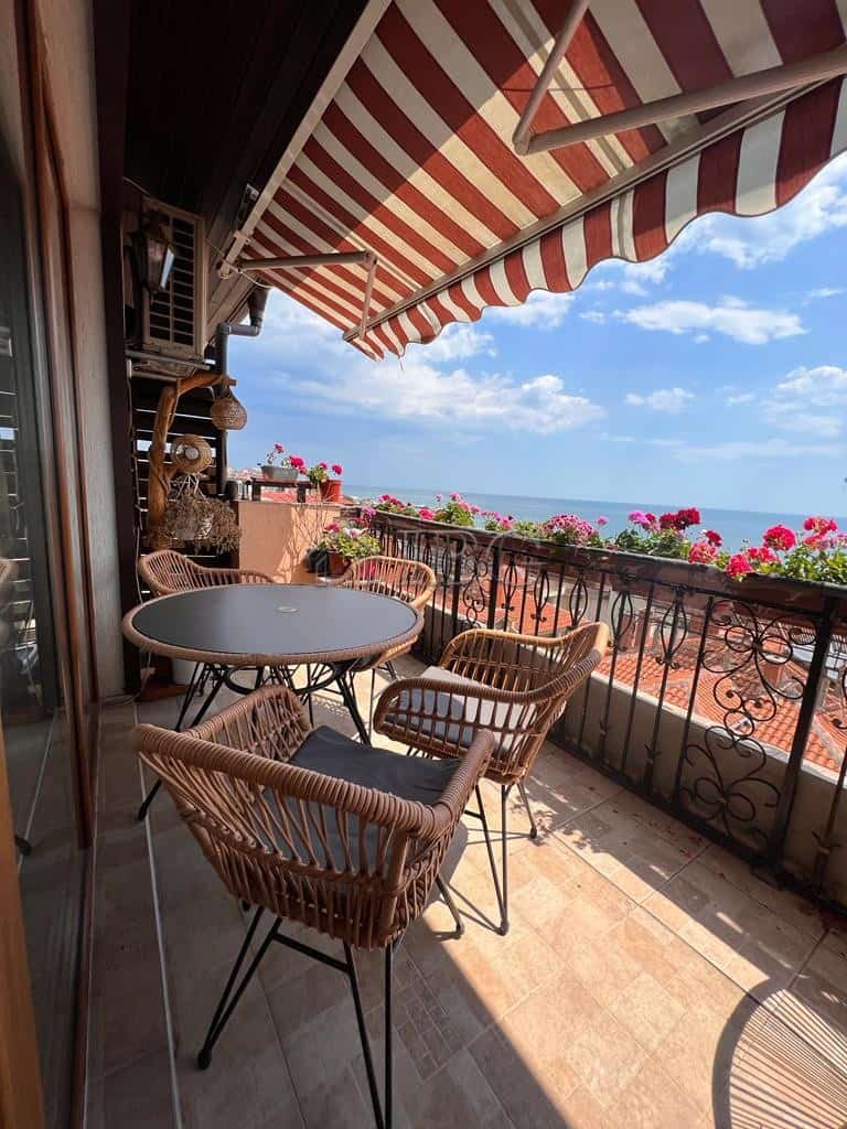 Bright balcony with panoramic sea views and outdoor seating in Sveti Vlas.
