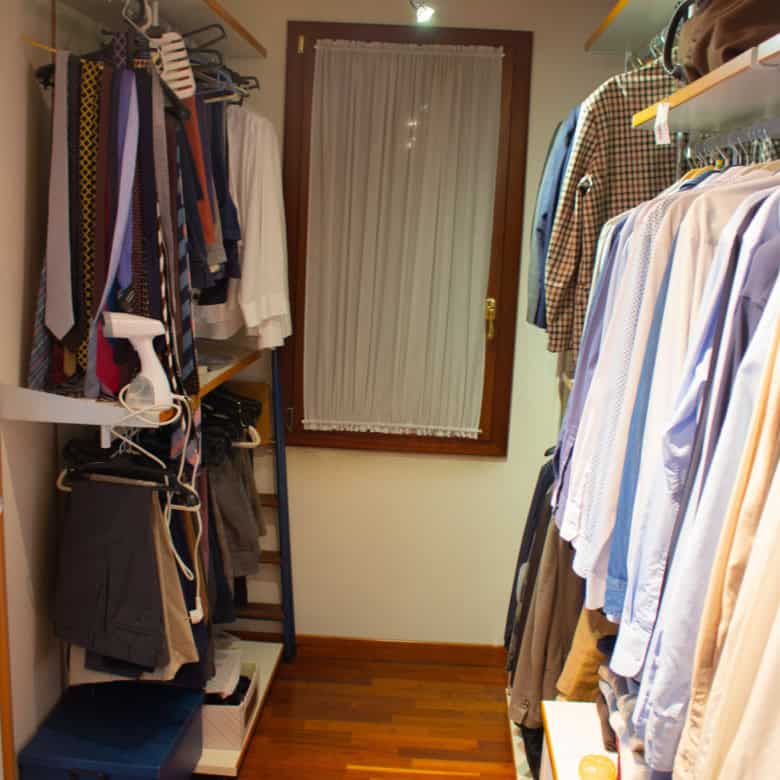 Walk-in closet with organized clothing racks and shelves.
