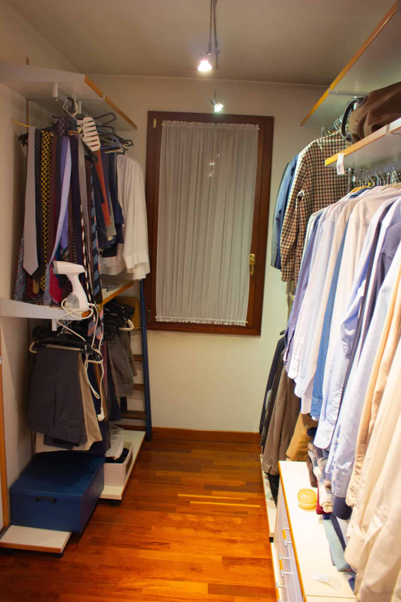 Walk-in closet with organized clothing racks and shelves.