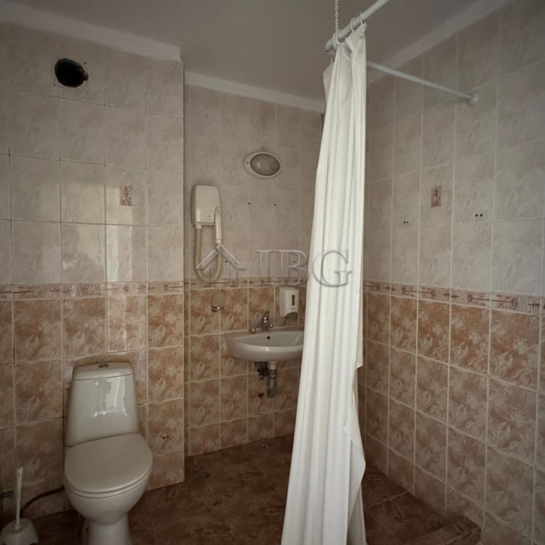 Hotel bathroom with toilet and shower area in Sunny Beach.