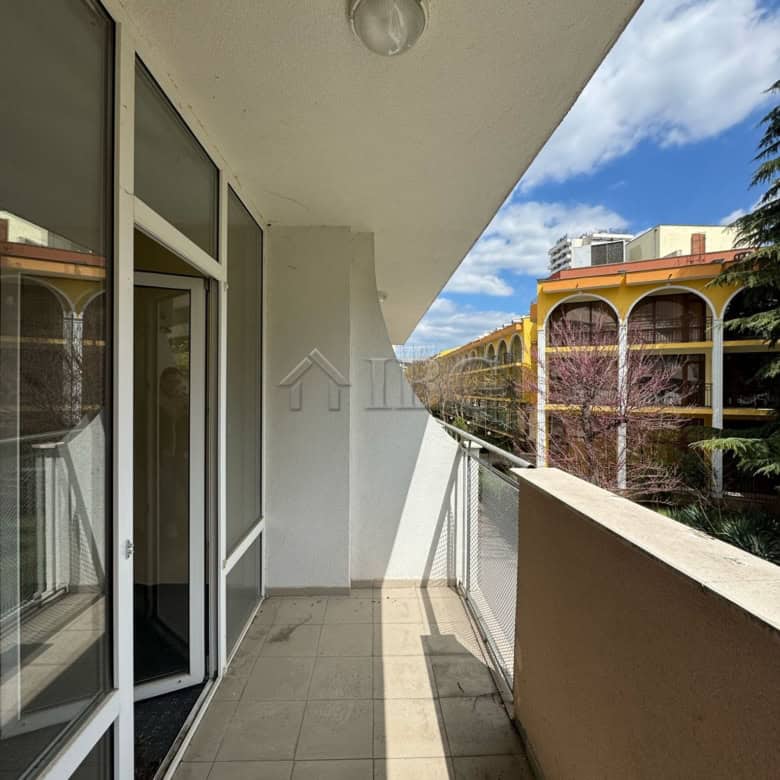 Balcony overlooking Sunny Beach with views of nearby hotels and lush greenery. Perfect for relaxing.