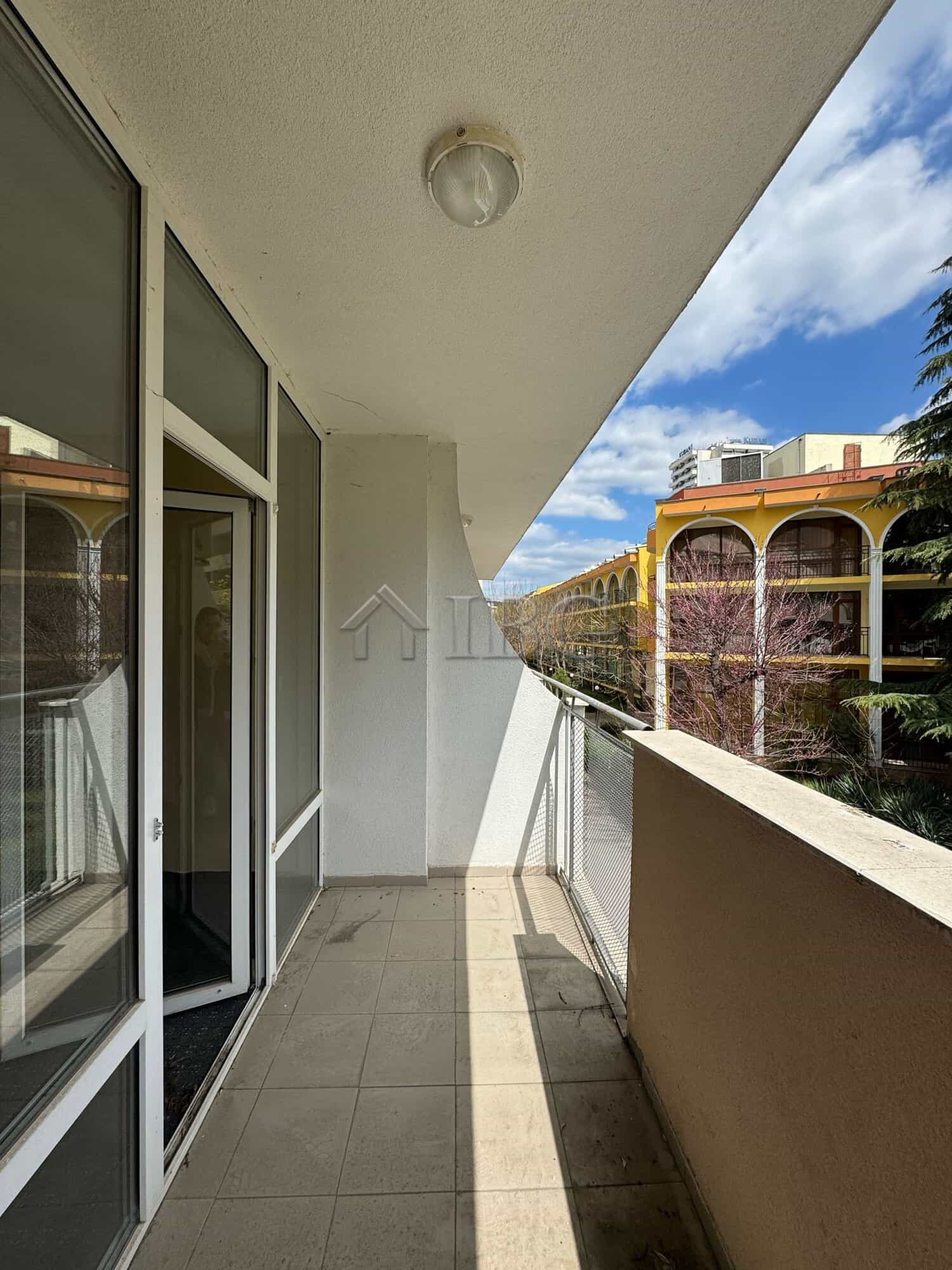 Balcony overlooking Sunny Beach with views of nearby hotels and lush greenery. Perfect for relaxing.