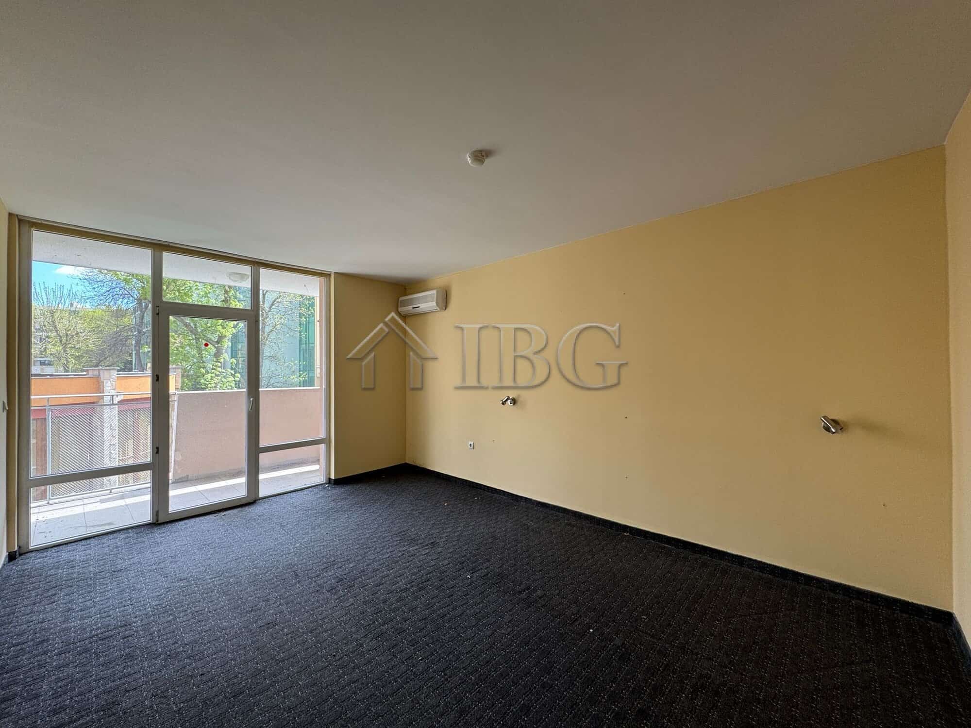Spacious hotel room with large windows and balcony, ideal for investment or hospitality business in.