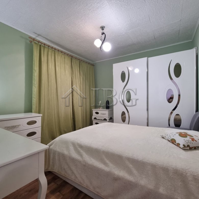Cozy bedroom with wardrobe and window view in Vinarsko Village, Burgas.