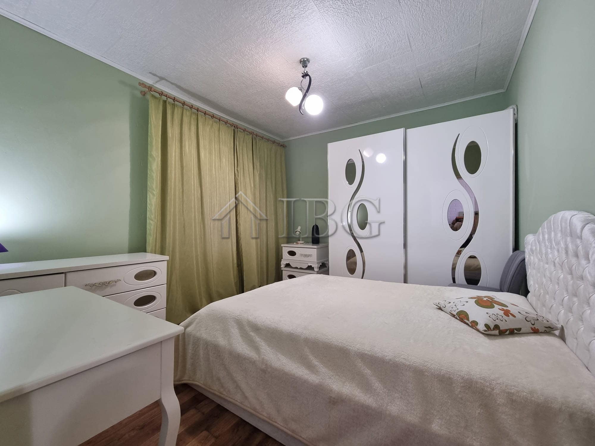 Cozy bedroom with wardrobe and window view in Vinarsko Village, Burgas.