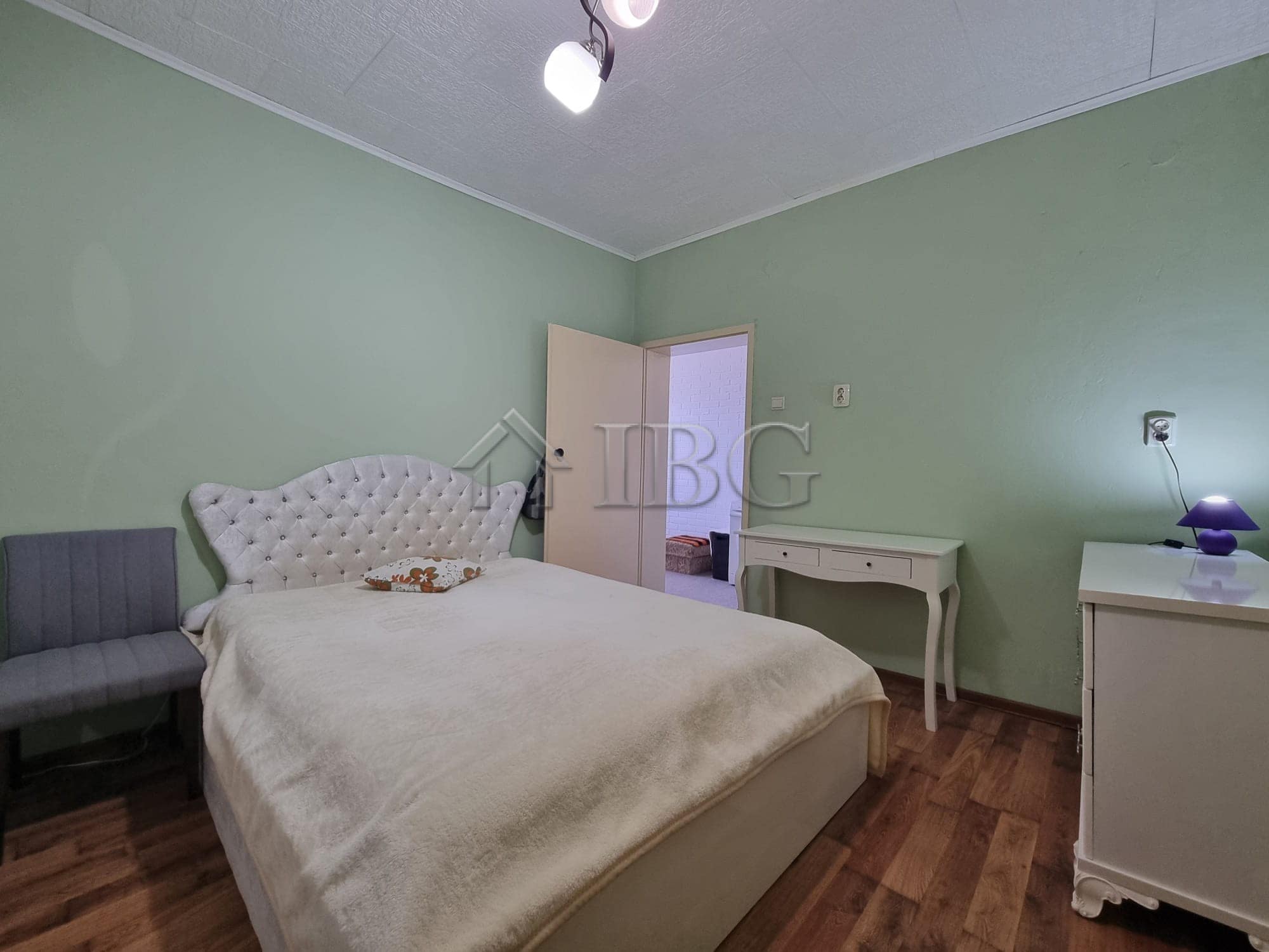 Comfortable bedroom with green walls and classic furniture in Vinarsko Village, Burgas Region.