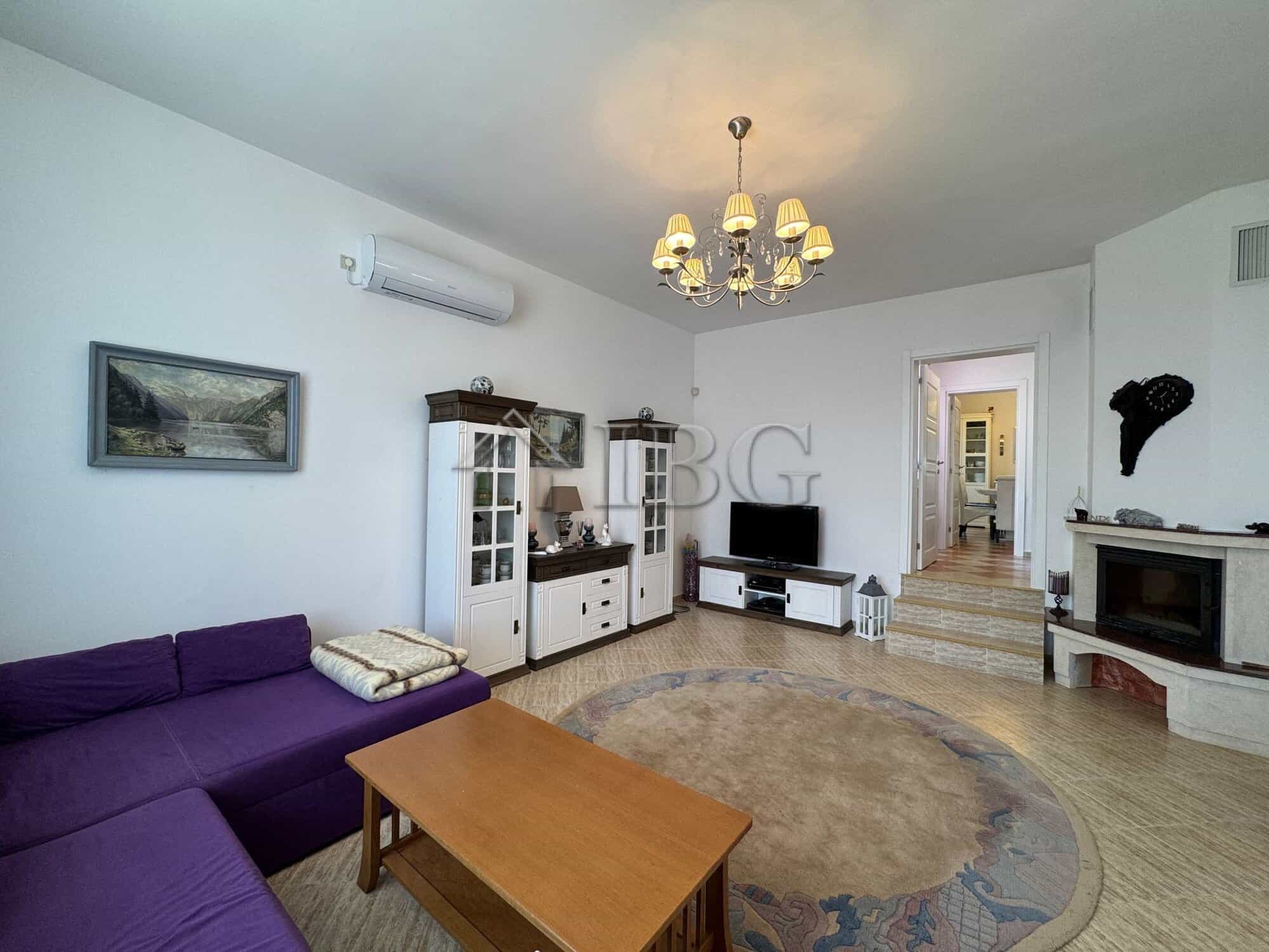 Bright living room with modern furniture and cozy decor in a two-storey house near the sea.