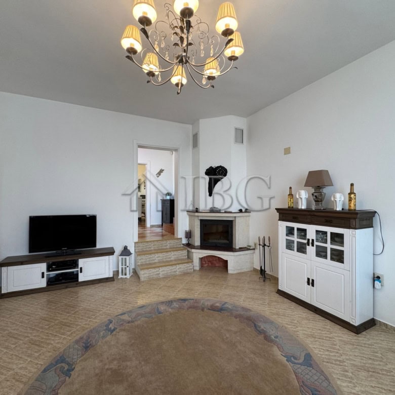 Bright living room with elegant furniture and a chandelier in Kosharitsa home.
