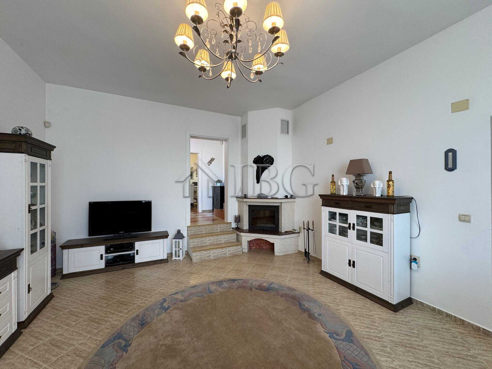 Bright living room with elegant furniture and a chandelier in Kosharitsa home.