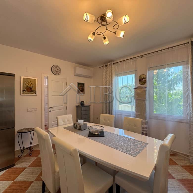 Bright dining room with large windows and modern decor in Kosharitsa.