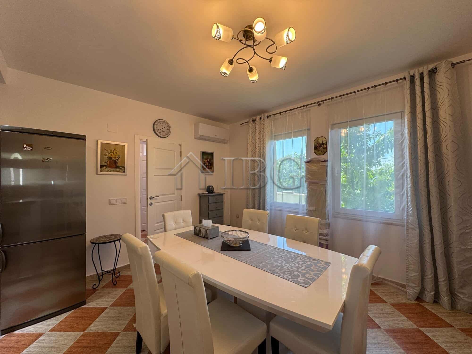 Bright dining room with large windows and modern decor in Kosharitsa.