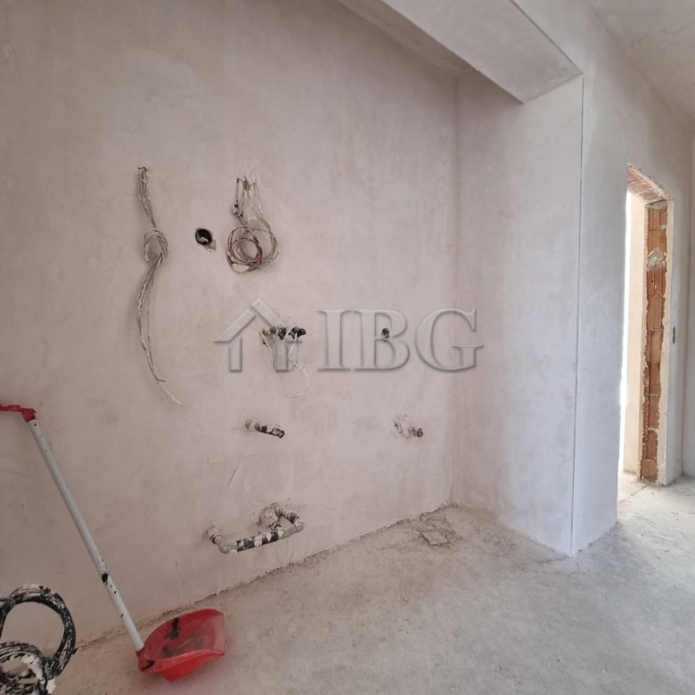 Modern house under construction with visible wiring and unfinished walls, located in Banya Village n.