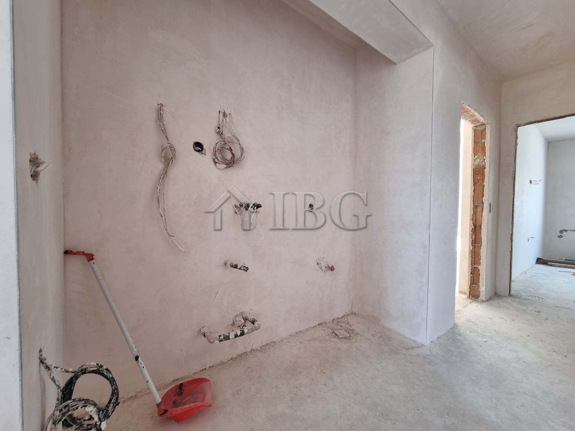 Modern house under construction with visible wiring and unfinished walls, located in Banya Village n.