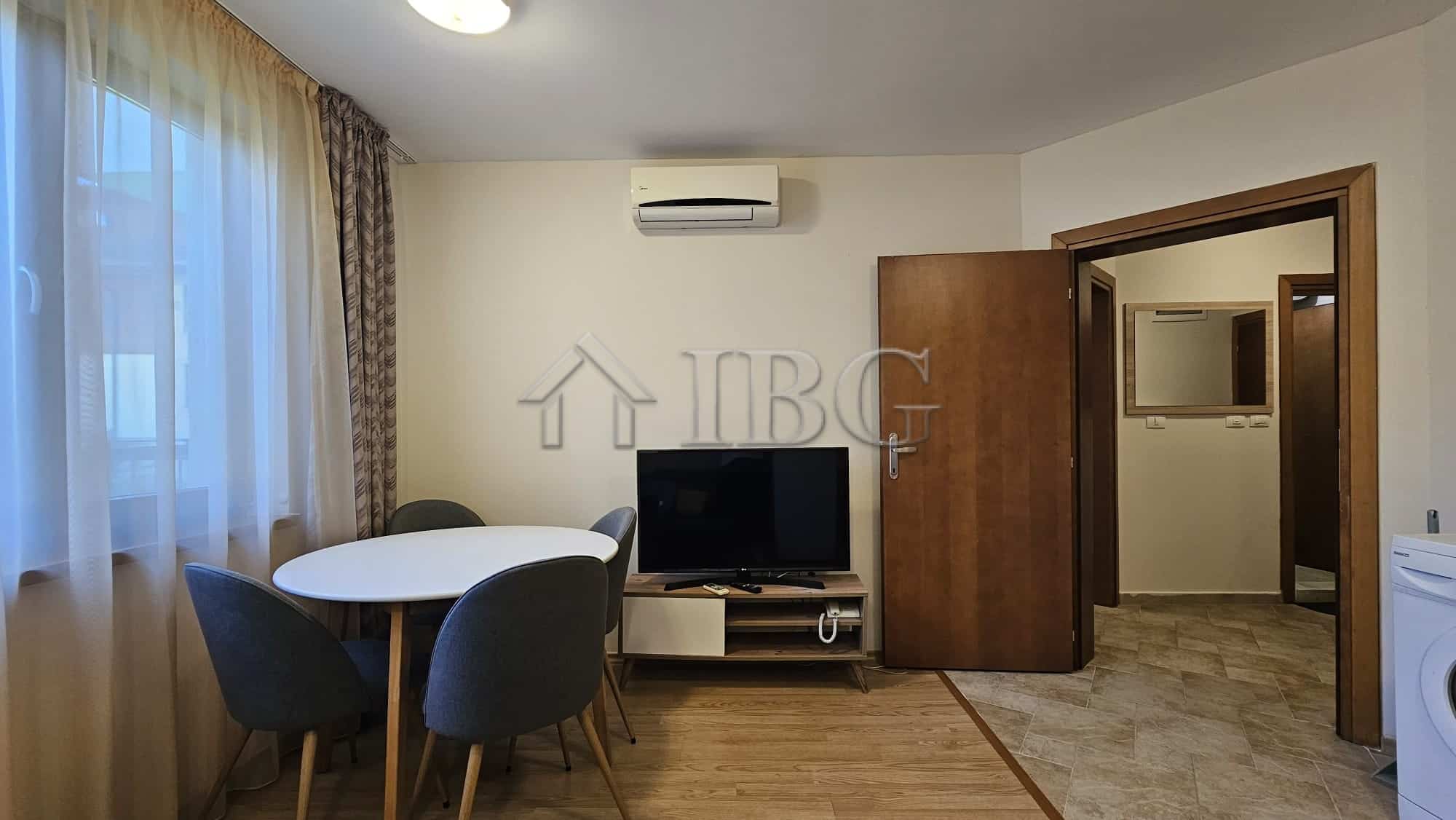 Bright living room with park view and modern furnishings.