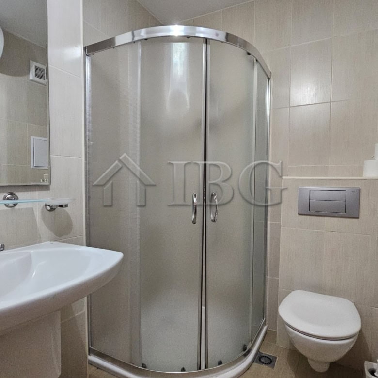 Bathroom with shower enclosure and modern fixtures.