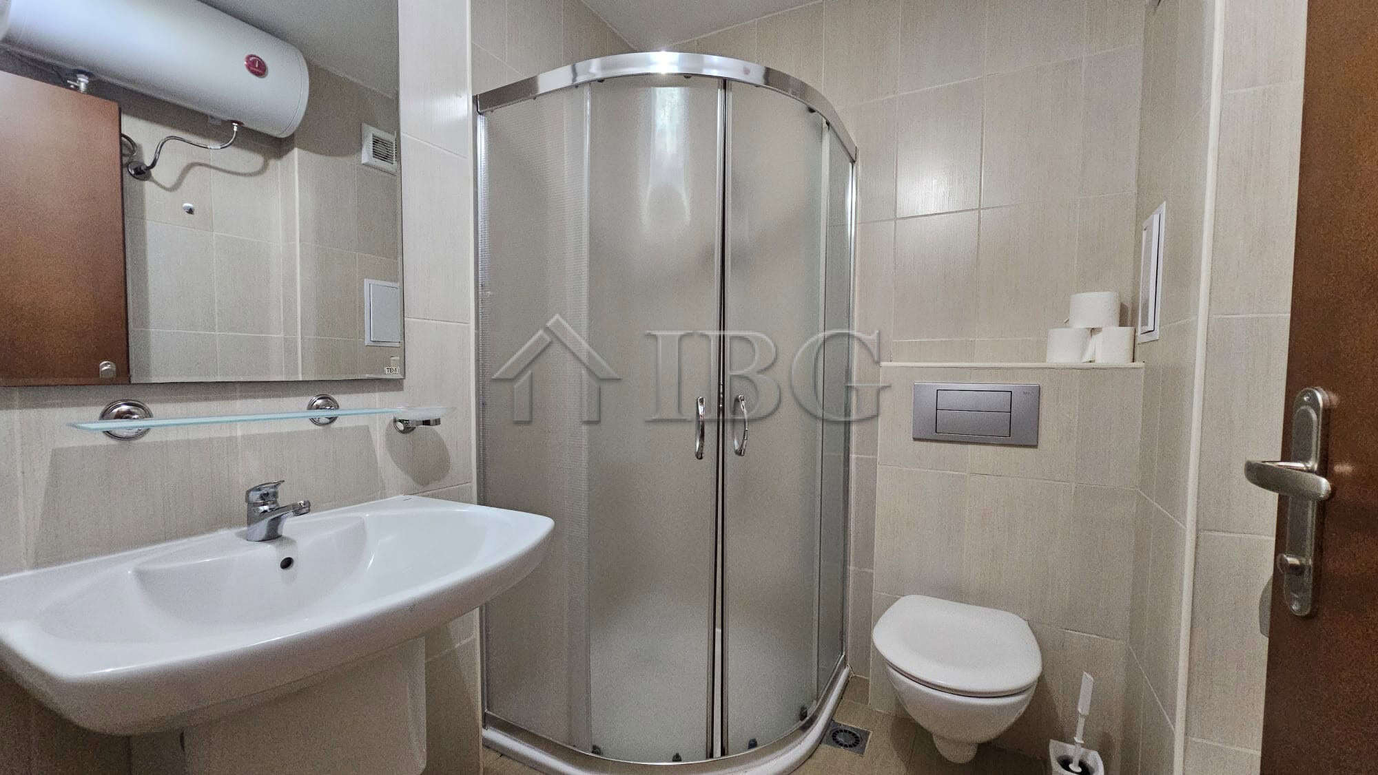 Bathroom with shower enclosure and modern fixtures.