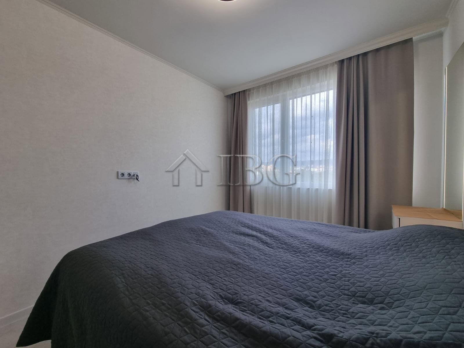 Modern 1-bedroom apartment with large window and natural light in Sunny Beach.