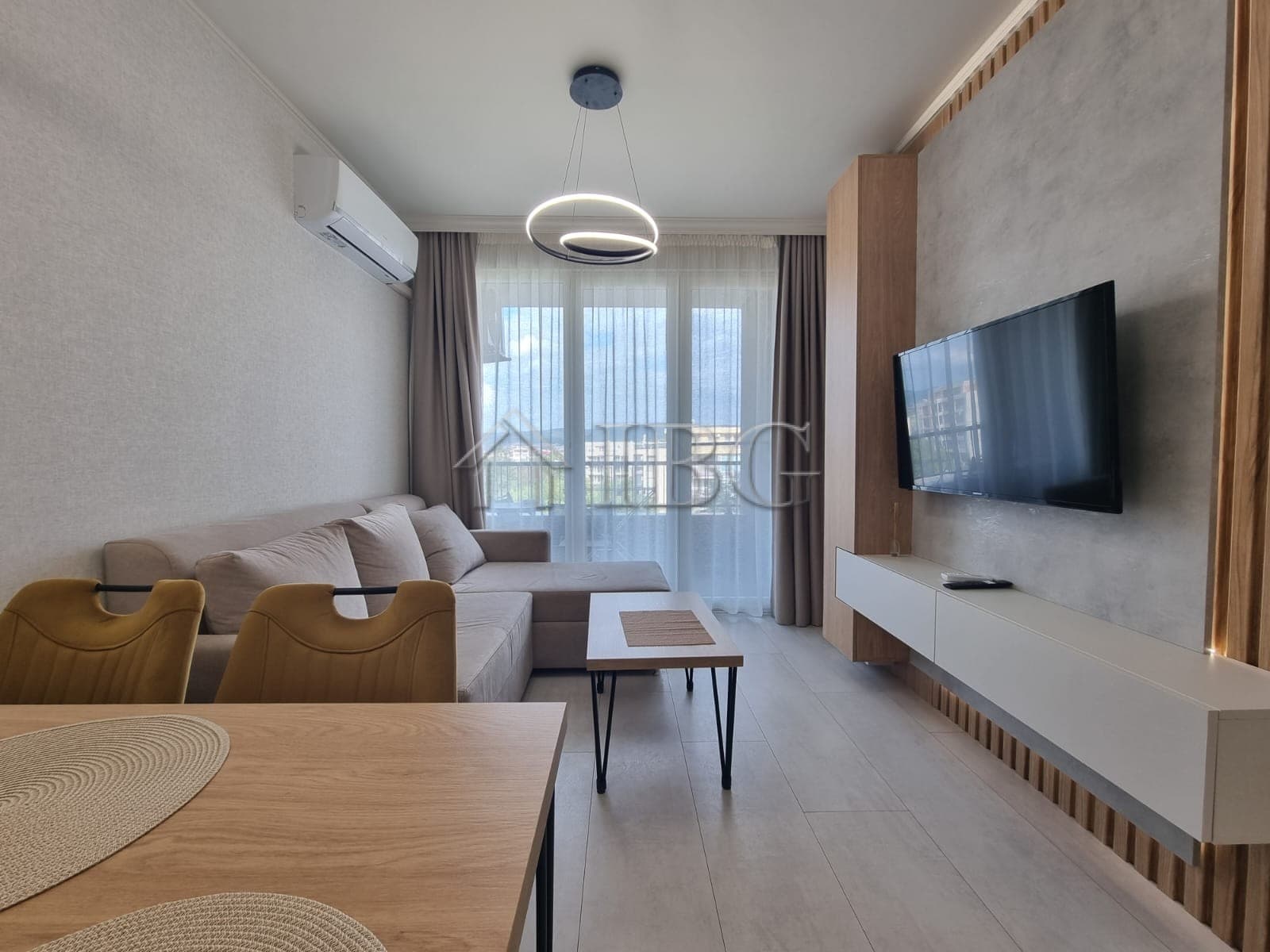 Bright 1-bedroom apartment with living area, TV, and balcony in Domenico Complex, Sunny Beach.