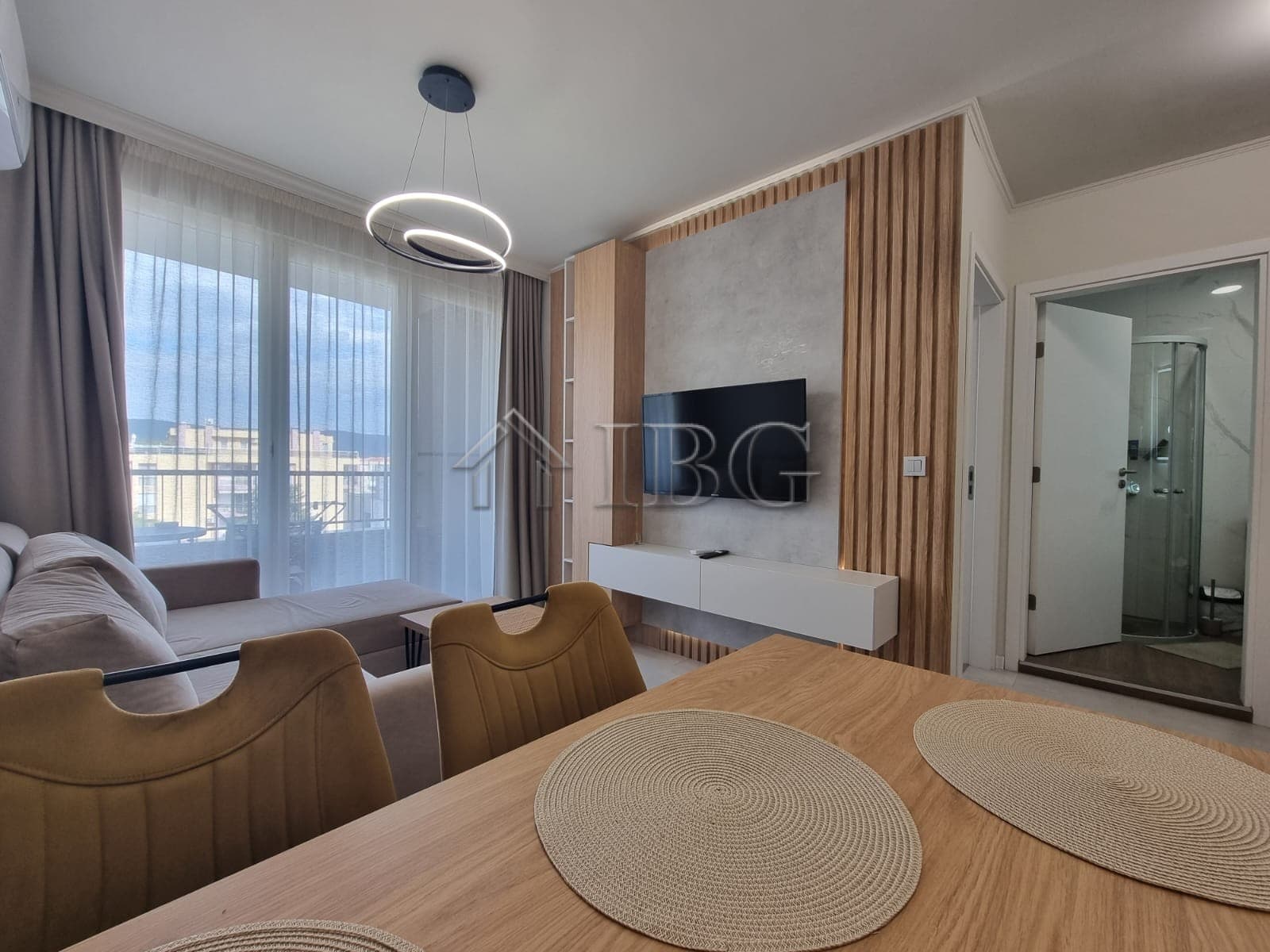 Bright 1-bedroom apartment with living area, modern decor, and balcony in Sunny Beach.