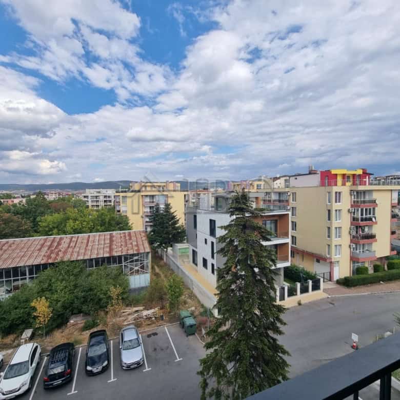 Apartment building in Sunny Beach with colorful exterior and surrounding greenery.