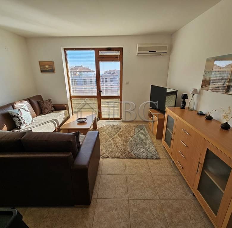 Bright living room with sea view, modern furniture, and balcony in Sveti Vlas apartment.