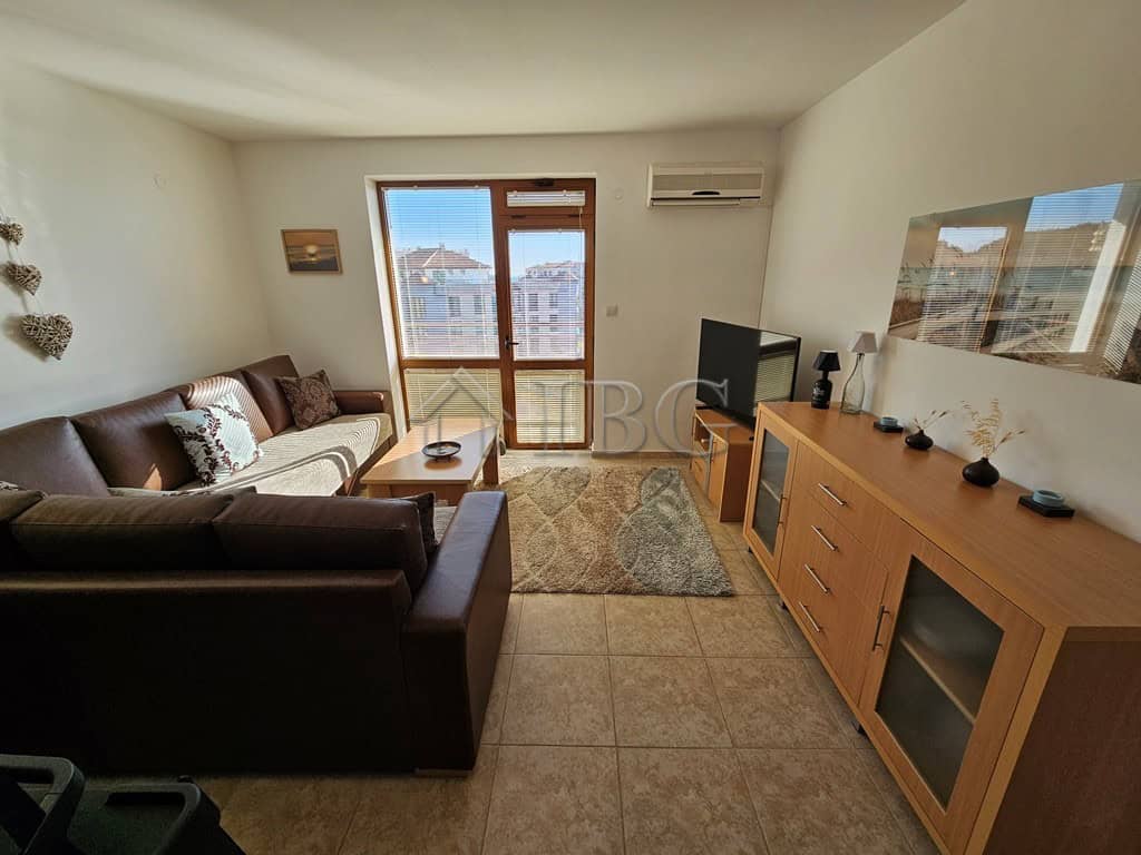 Bright living room with sea view, modern furniture, and balcony in Sveti Vlas apartment.