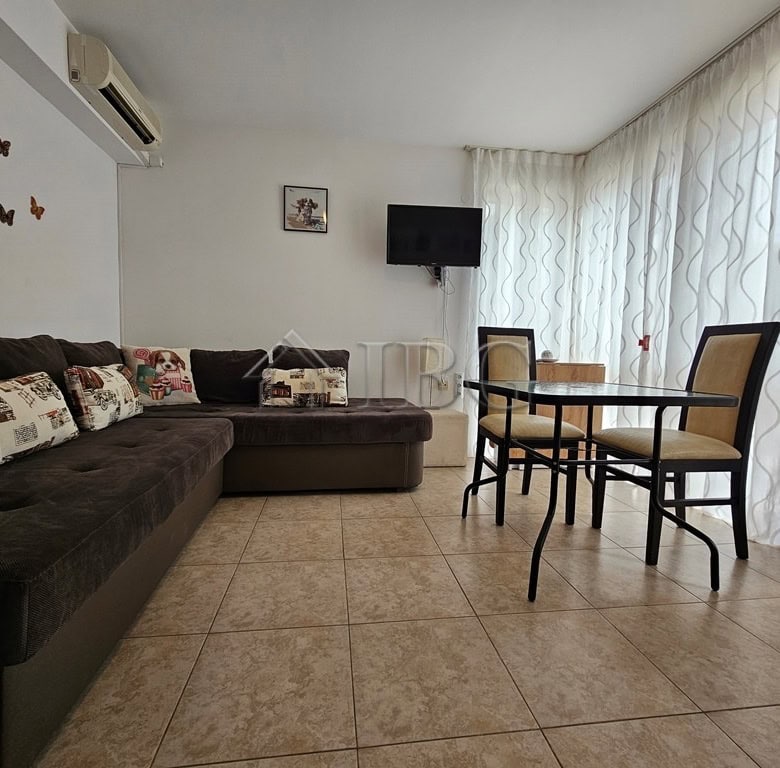 Apartment with pool view in Sveti Vlas, Dinevi Resort, featuring a living area, dining table, and mo.