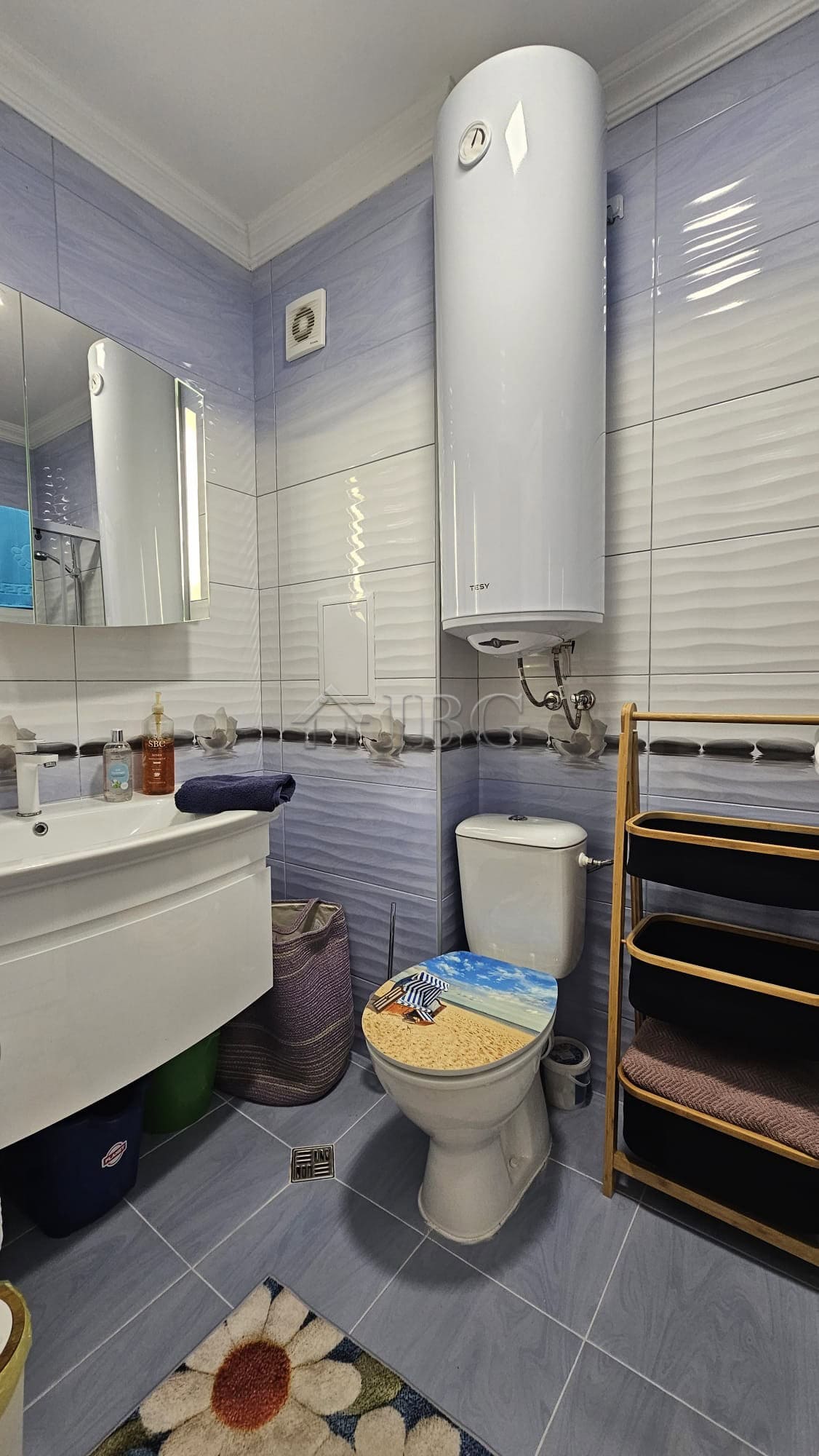 Bright bathroom with modern fixtures in Magnolia 6, Sunny Beach. Features a water heater, mirror, an.