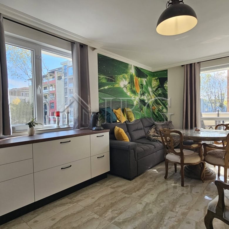 Bright living room with large windows and balcony views in Sunny Beach. Modern decor and comfortable.