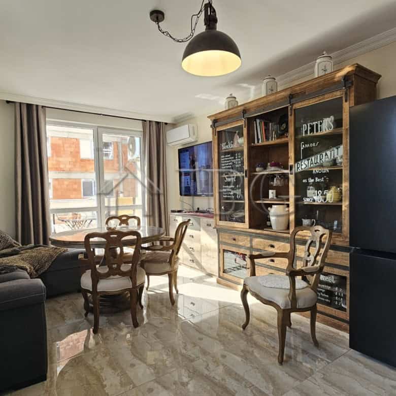Bright living room with large windows and modern furniture in Sunny Beach.