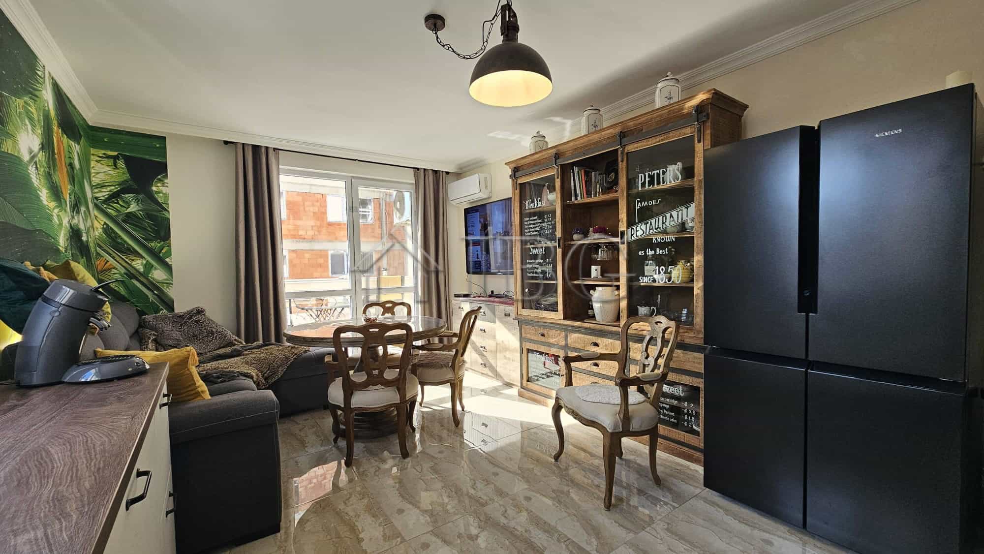 Bright living room with large windows and modern furniture in Sunny Beach.