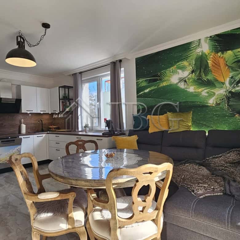 Bright living room with tropical-themed wall mural and modern furnishings.