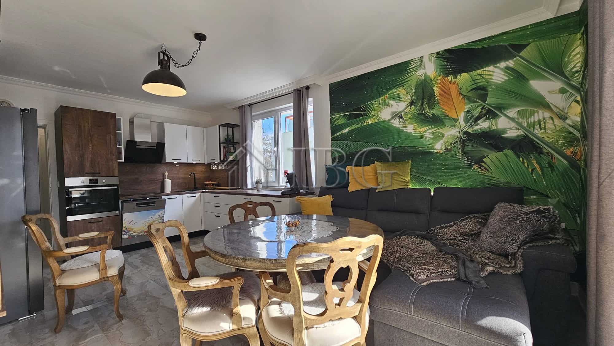 Bright living room with tropical-themed wall mural and modern furnishings.